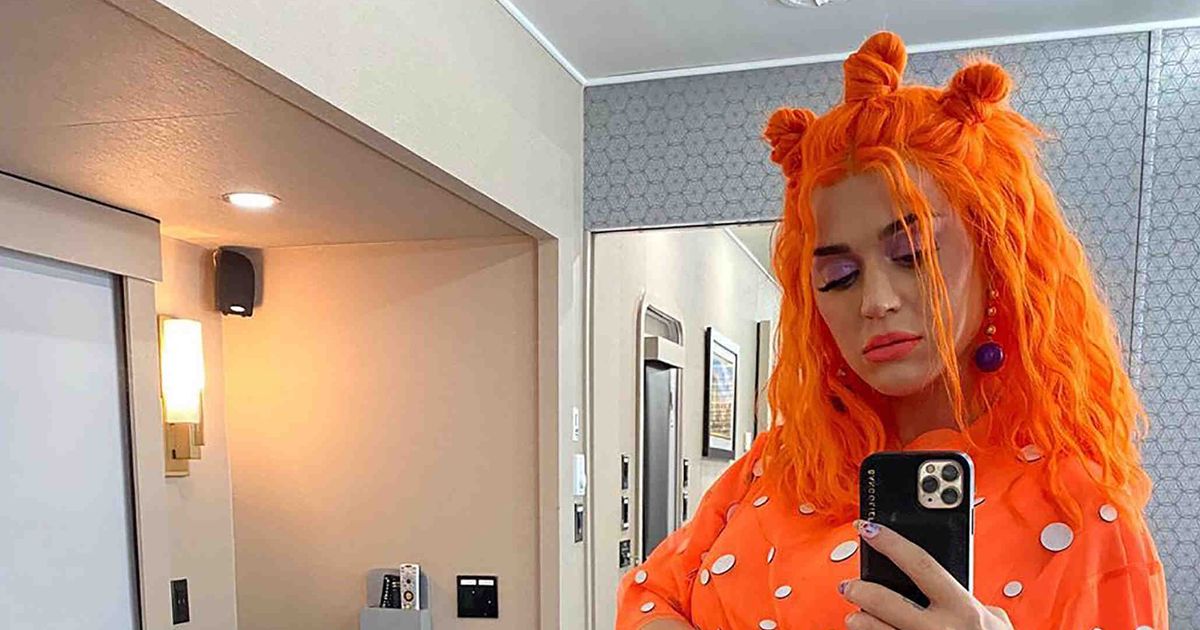 Pregnant Katy Perry flaunts baby bump in garish orange dress and matching hair