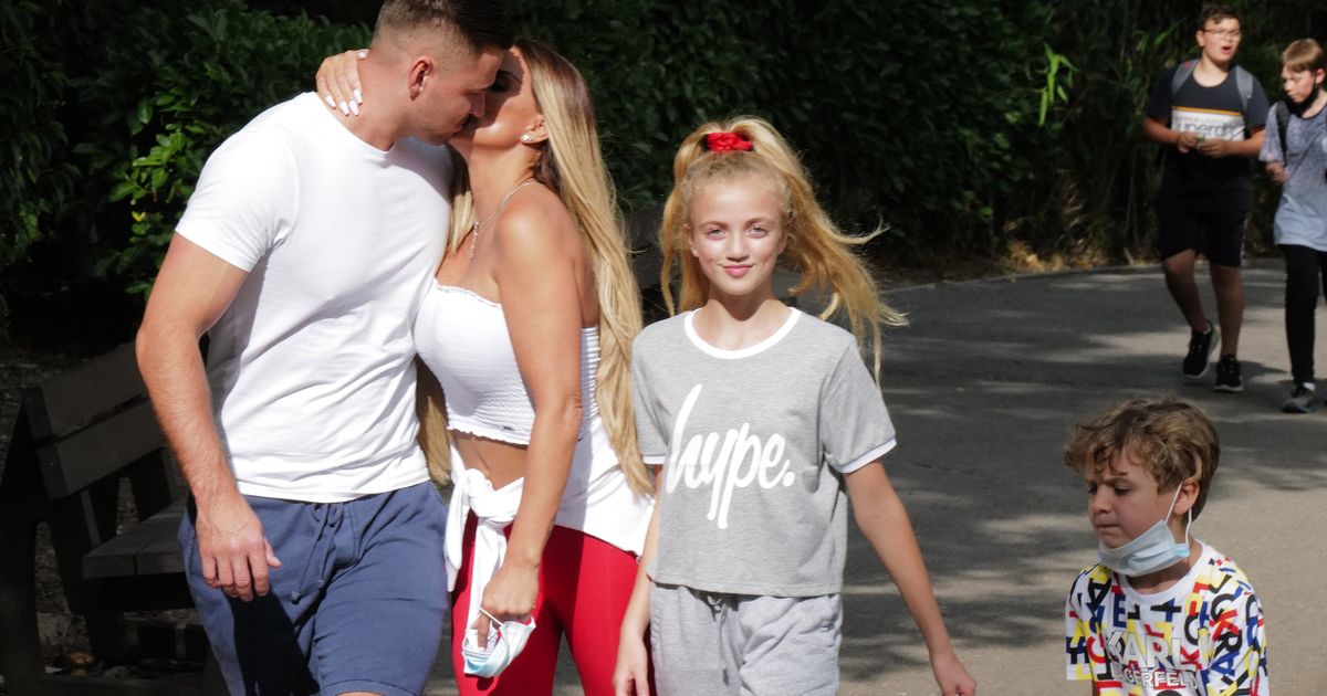 Katie Price snogs Carl Woods on family theme park day to get over puppy’s death