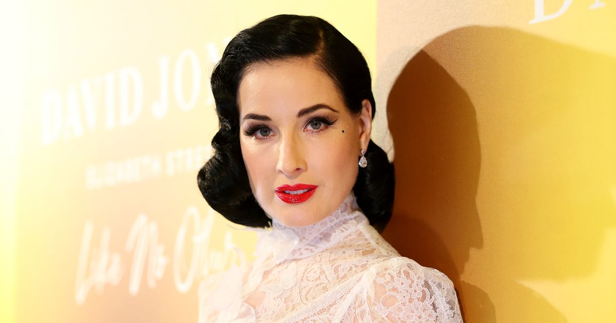 Dita Von Teese unveils impossibly tiny waist as she slips into sexy lace corset