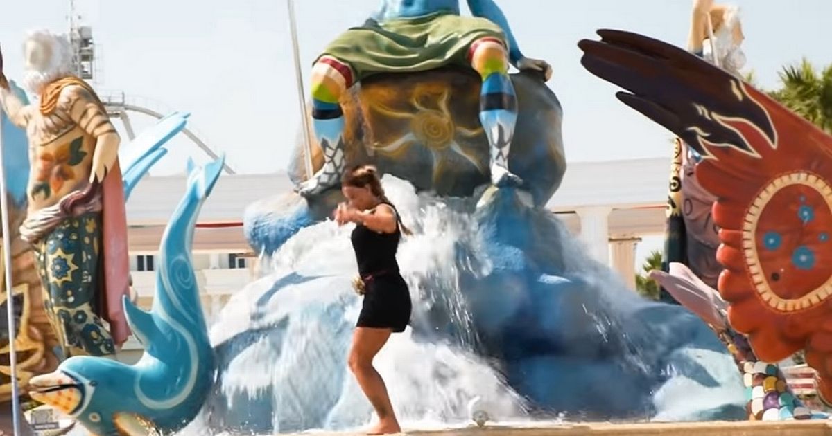 Katie Price dances on a fountain at water park moments before breaking her feet