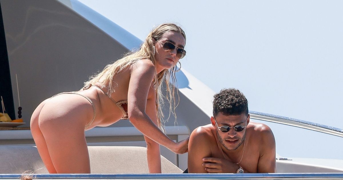 Perrie Edwards oozes sexiness as she goes paddle boarding in a thong bikini