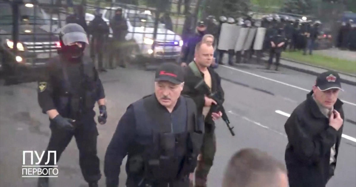 Armed Belarus president defiant as protesters demand resignation