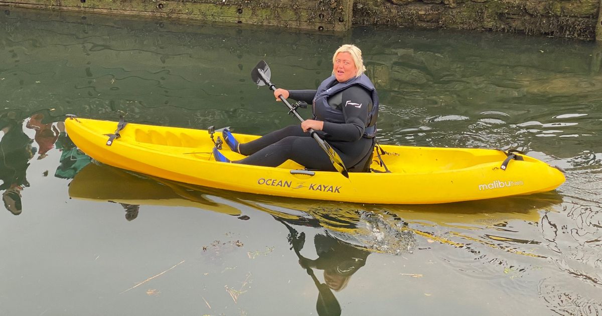 Gemma Collins swaps glam frocks for a wetsuit as she paddles a canoe in the rain