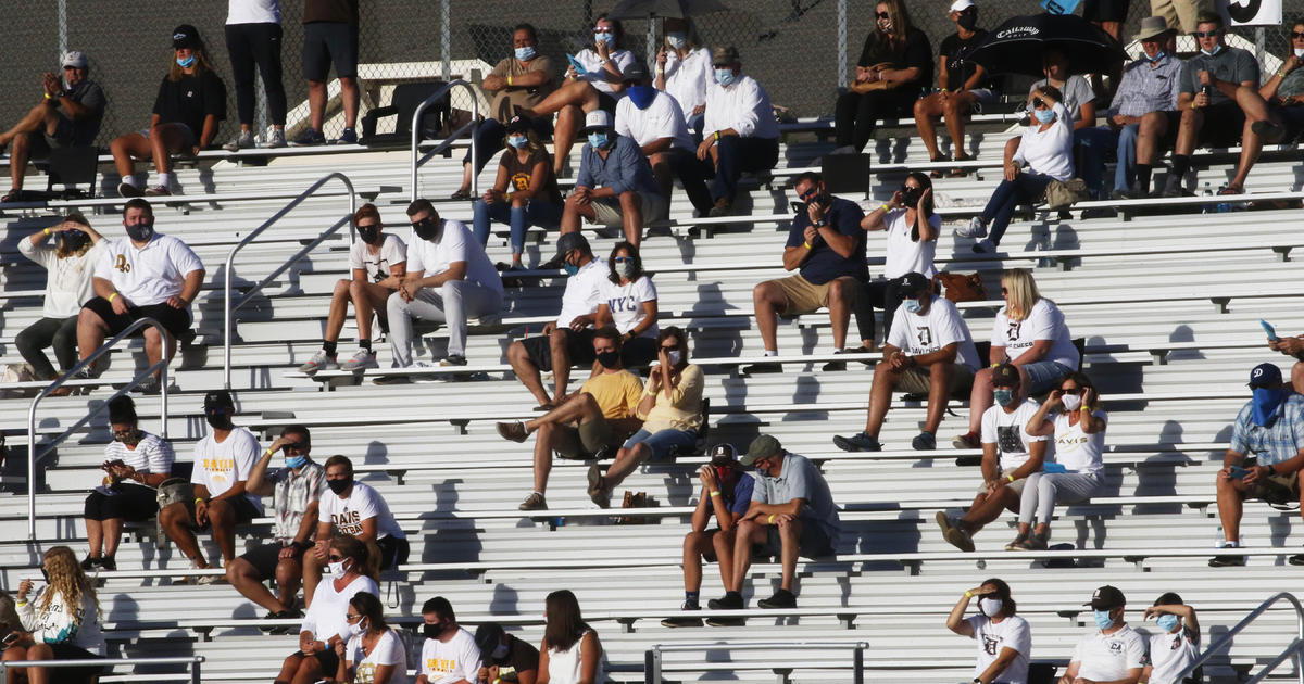 Strict curbs at pandemic’s apparent first high school football game