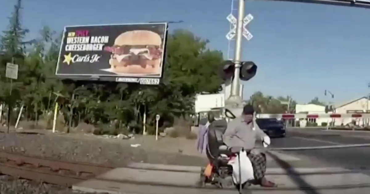 Video shows officer rescuing man in wheelchair before train barrels past