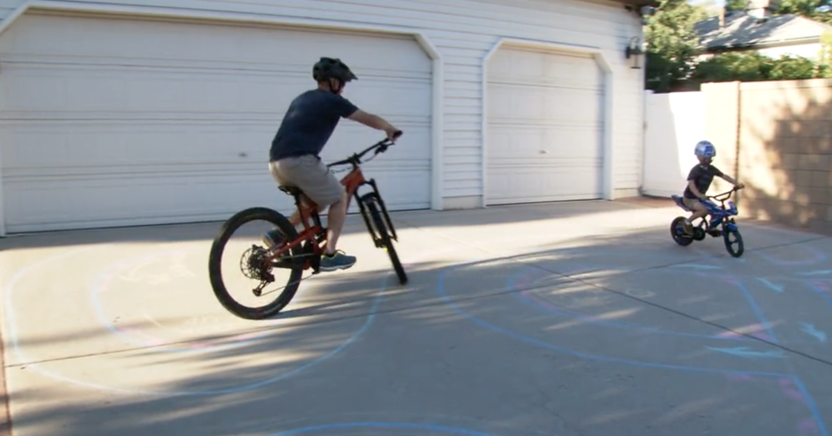 Driveway racetrack brings man and young boy together