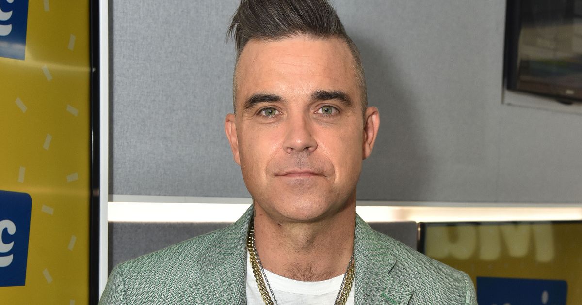 Robbie Williams confesses he pooed in his own hand while trying to secretly fart