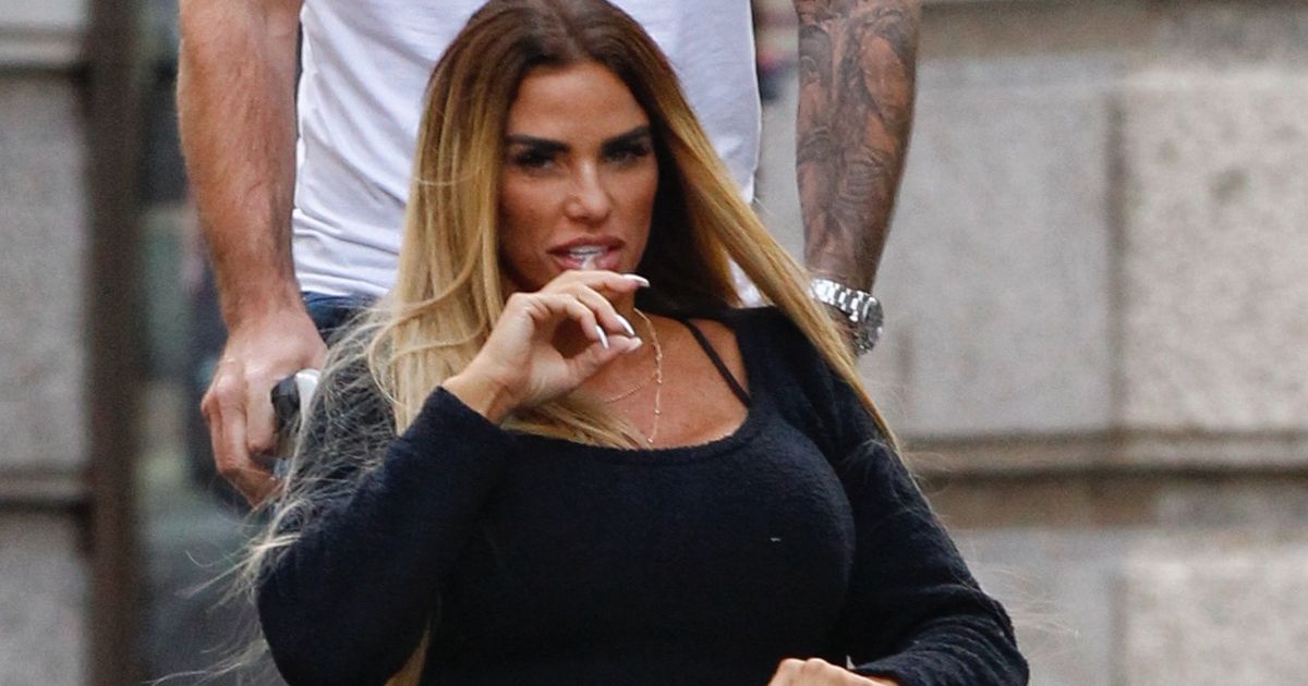 Katie Price winces in agony as boyfriend Carl Woods takes her for a slap-up meal