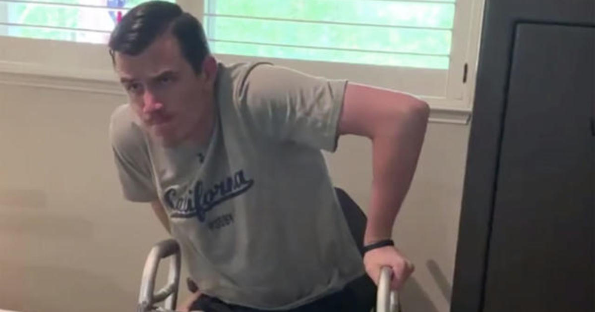 After 1,220 tries, man stands up from wheelchair for first time