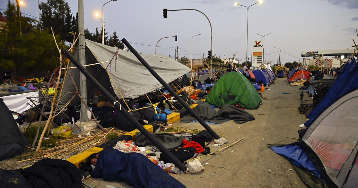 Thousands spend another night in the open after fires destroy refugee camp