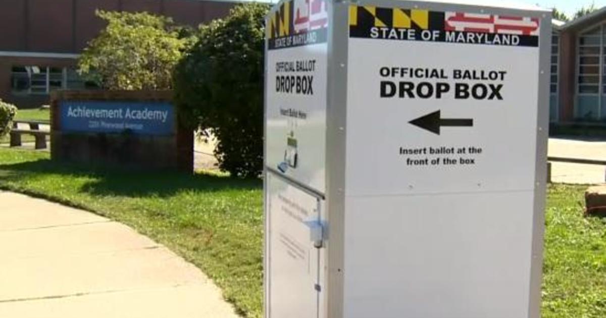 Security guard protecting ballot drop box shot