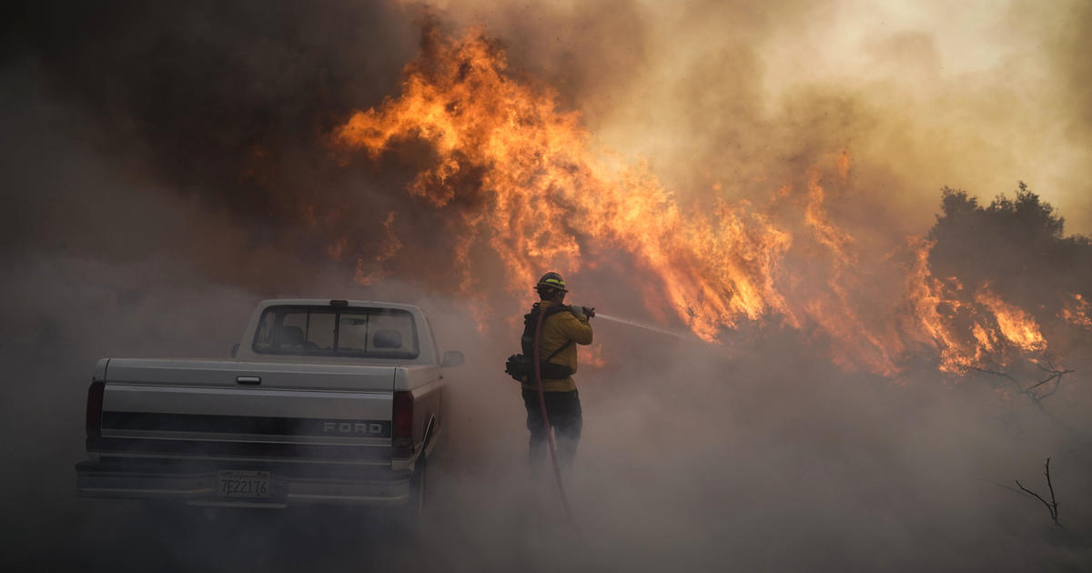 Wildfires explode in California, forcing more than 60,000 evacuations