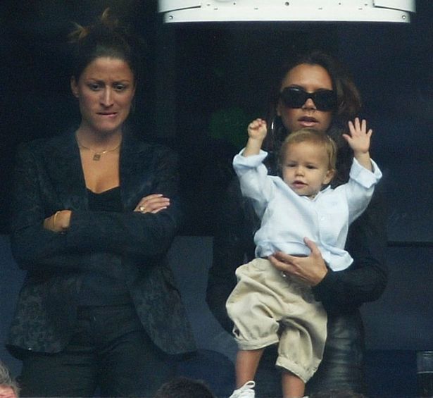 Rebecca pictured watching David play with his wife Victoria and son Romeo in 2003