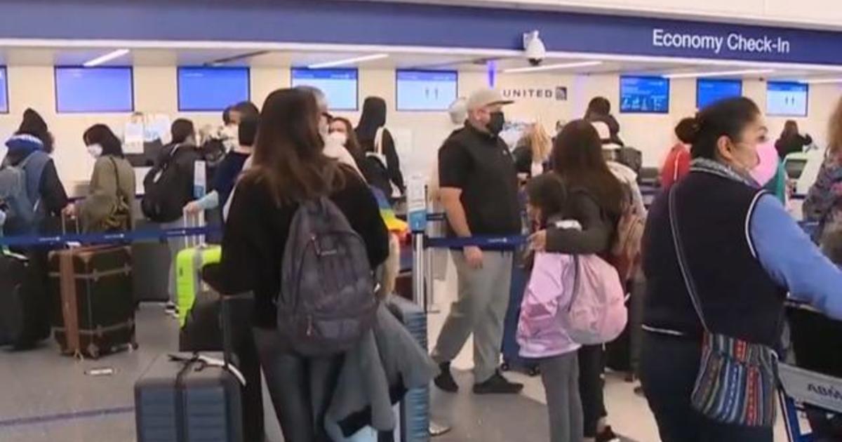 Millions pack airports, roads despite warnings from health experts