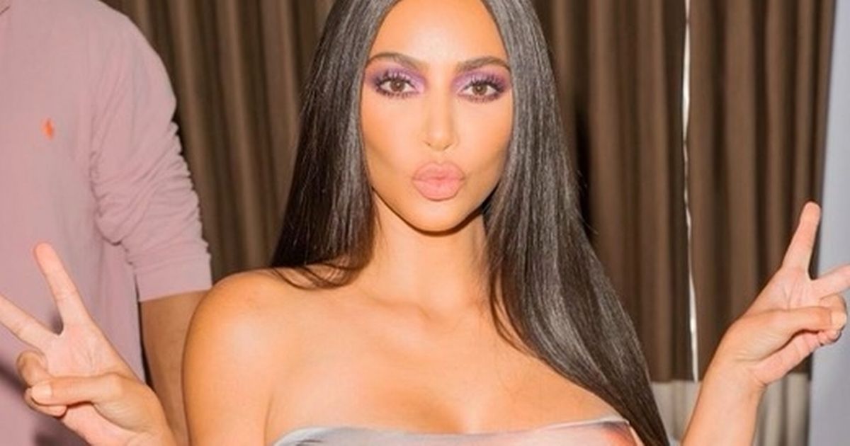 Kim Kardashian divides fans as she models own face in bizarre strapless dress