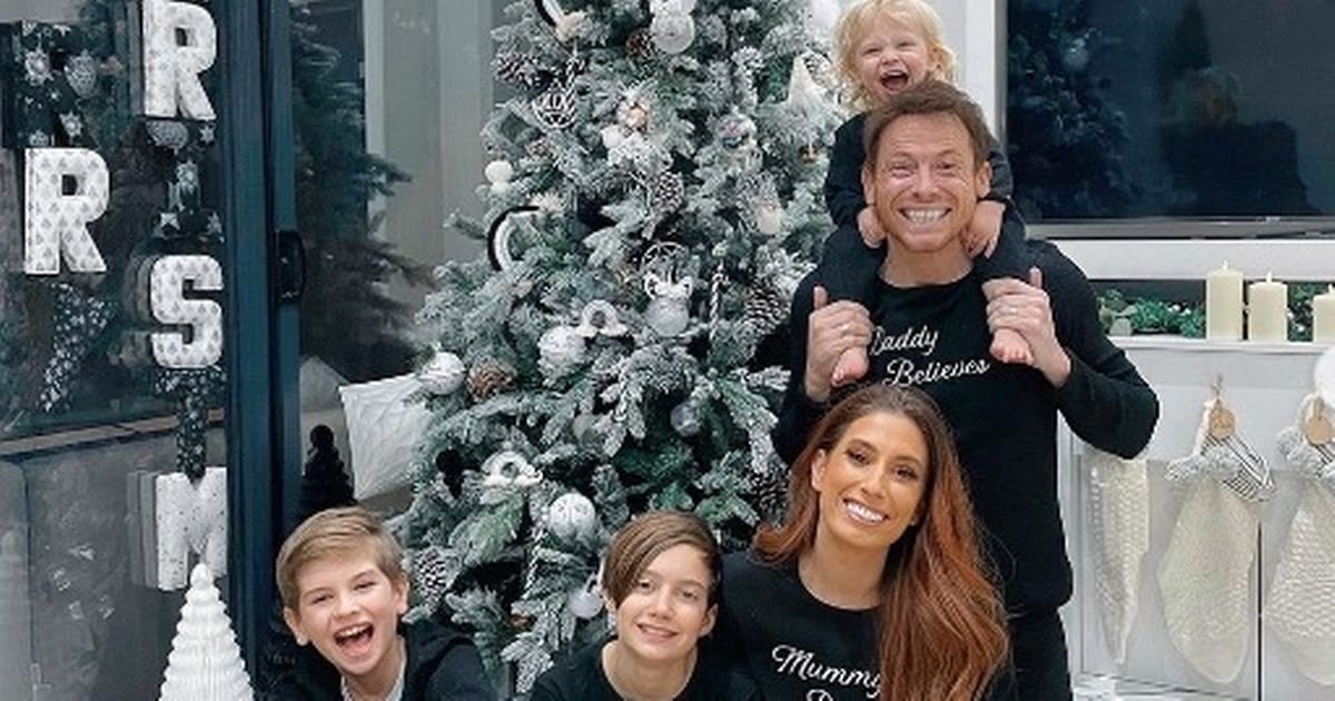 Stacey Solomon poses with Joe in matching PJs as they decorate the tree together