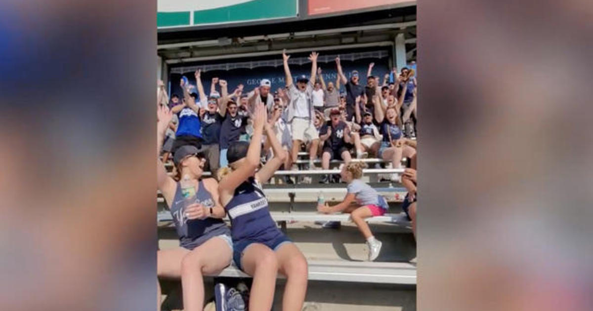 Baseball fans cheer for little girl’s’ water bottle trick