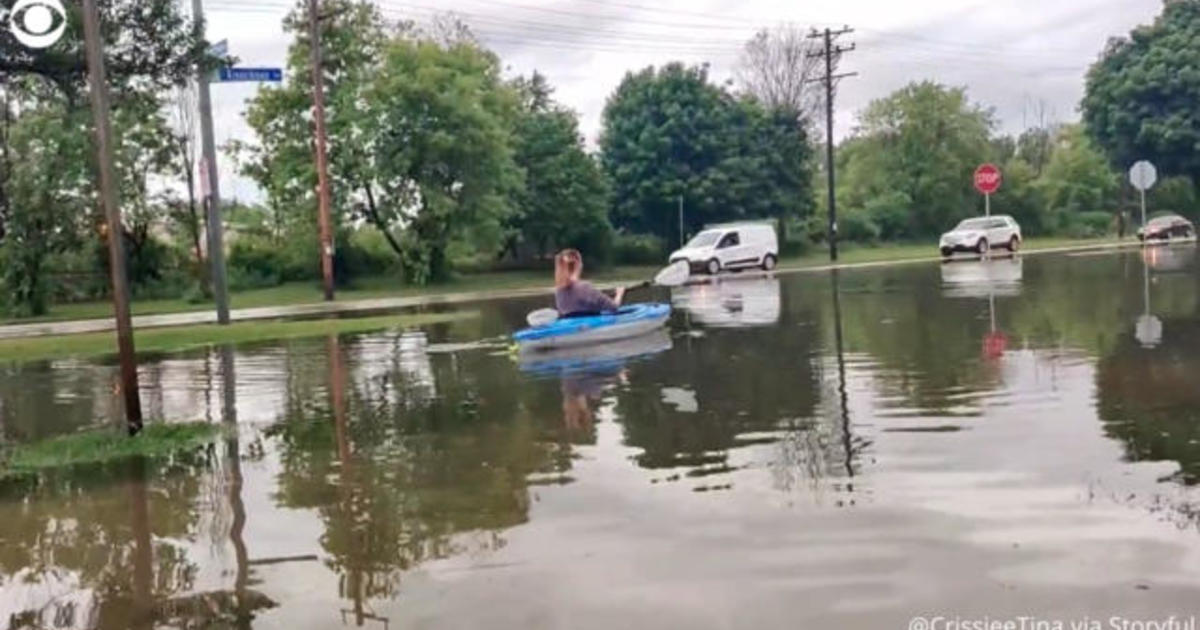 Wisconsin woman kayaks along street after downpours flood Milwaukee area