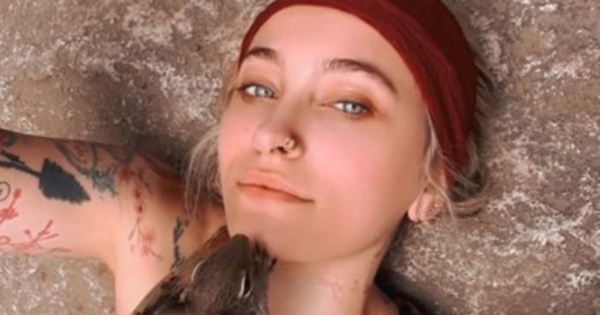 Paris Jackson lets a squirrel crawl over her chest and face on camping trip