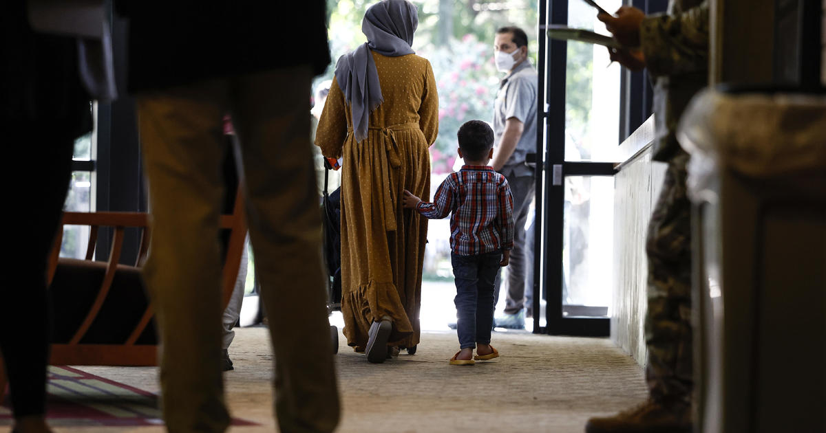 Afghan families start U.S. resettlement process at repurposed conference center