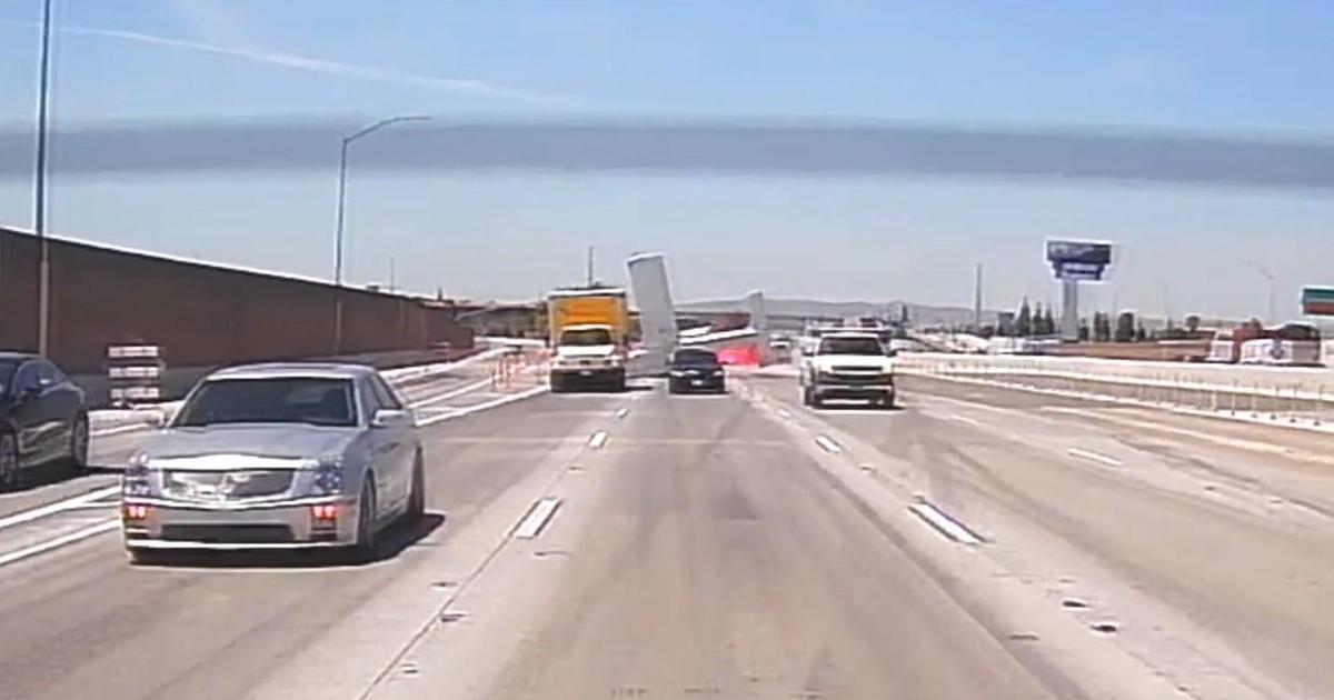 Small plane catches fire after crash-landing on California freeway