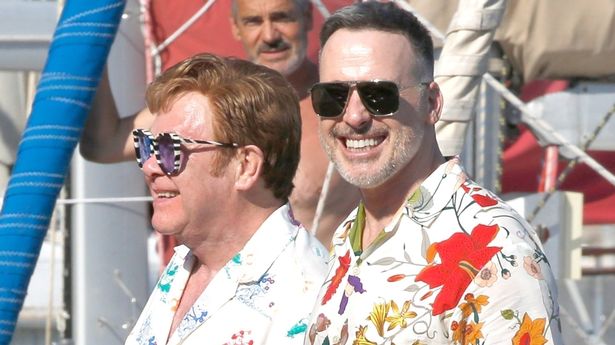 Elton John is a picture of health out of his wheelchair with hubby David Furnish